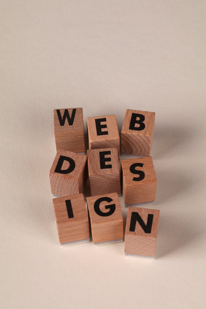 Wooden blocks arranged to spell 'Web Design'. Perfect for creative, digital content themes.